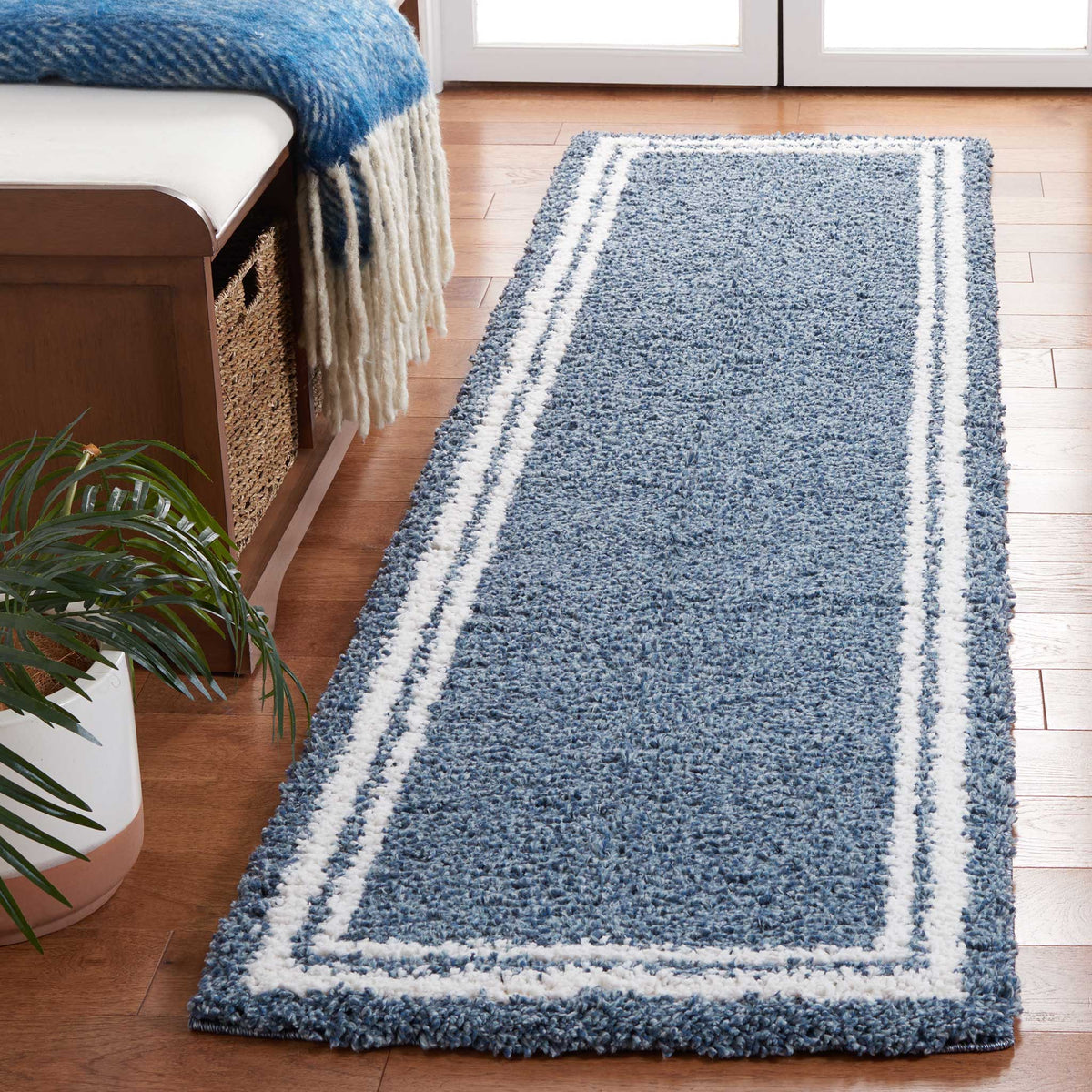 Dense blue shag pile framed by ivory stripes adds soft contrast to this runner.