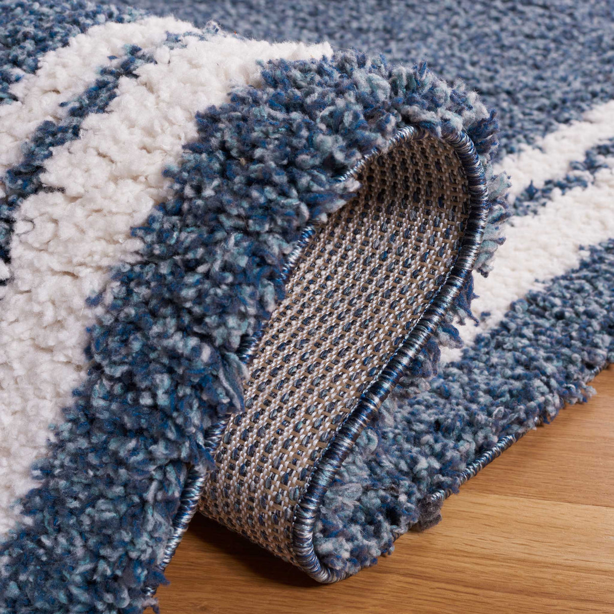 Deep blue and ivory pile folds to reveal a tightly woven backing