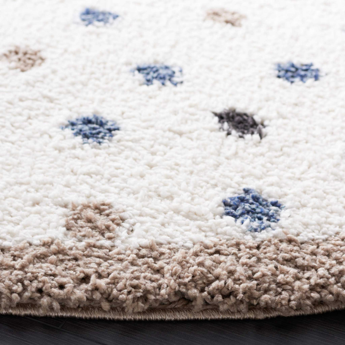 Plush taupe trim outlines ivory shag speckled with blue and charcoal dots