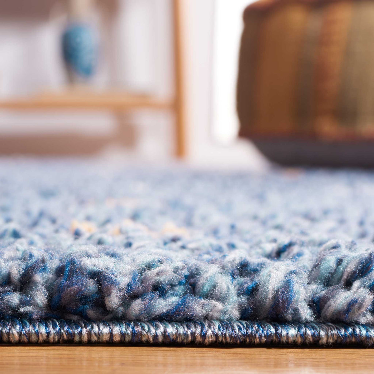 Deep blue shag fibers rise above a slim bound edge for cushioned comfort