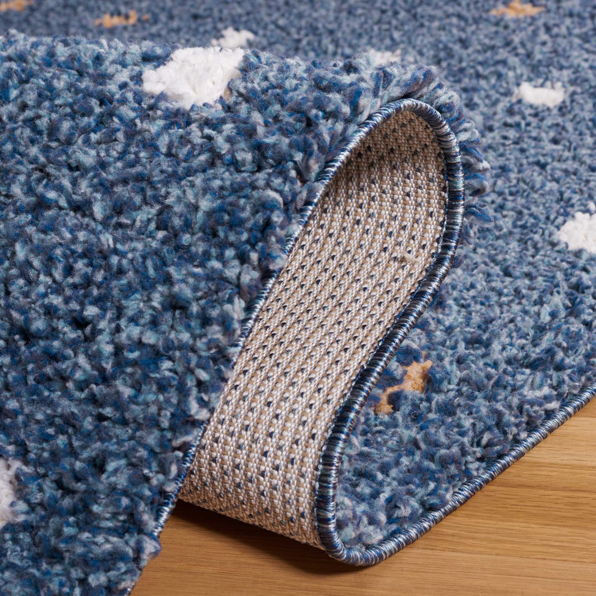 A turned-up blue pile reveals the rug's tightly woven underside