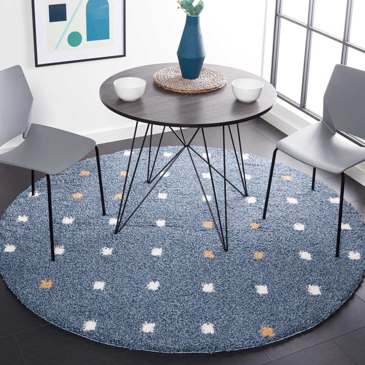 Playful ivory and gold dots brighten a blue round rug beneath a dining set