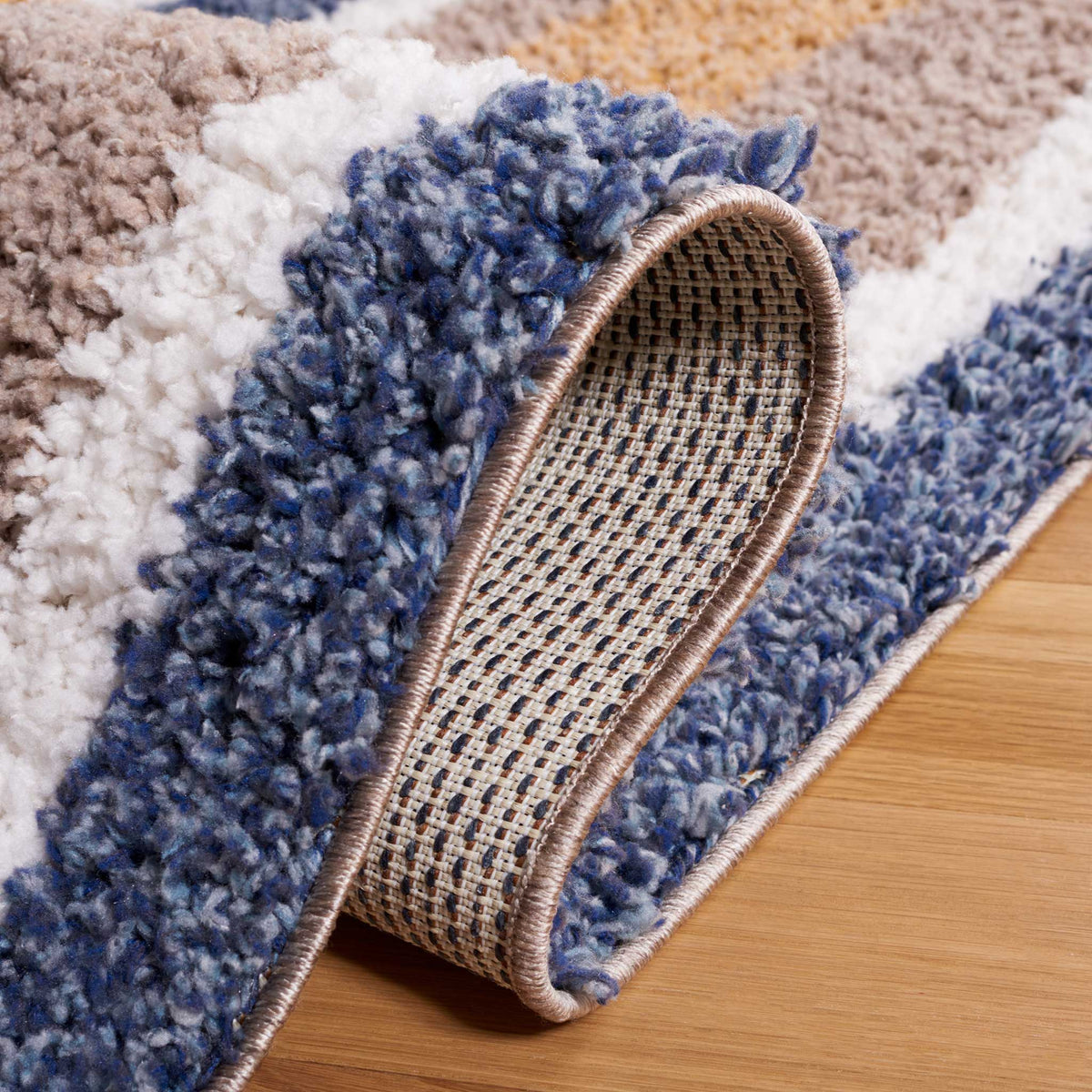 A soft blue stripe bends to reveal the woven backing below
