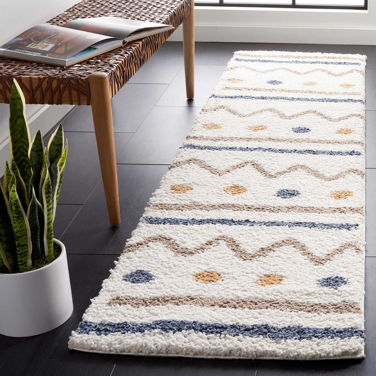 Plush ivory pile brings texture to repeating zigzags, dotted accents, and blue and taupe stripes.