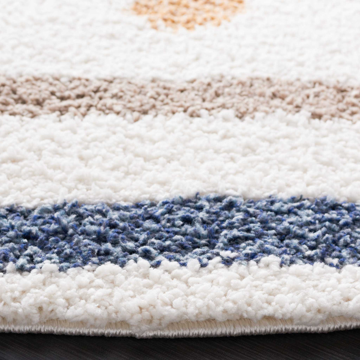 Thick ivory shag contrasts with a blue band and soft taupe line near the bound edge