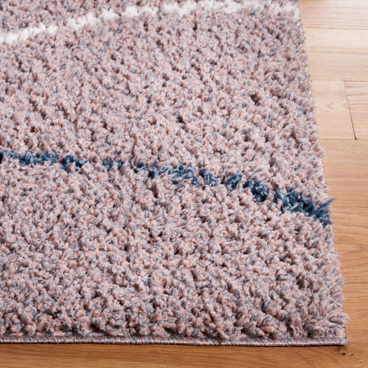 A thin blue line flows through soft taupe shag beside a finished edge