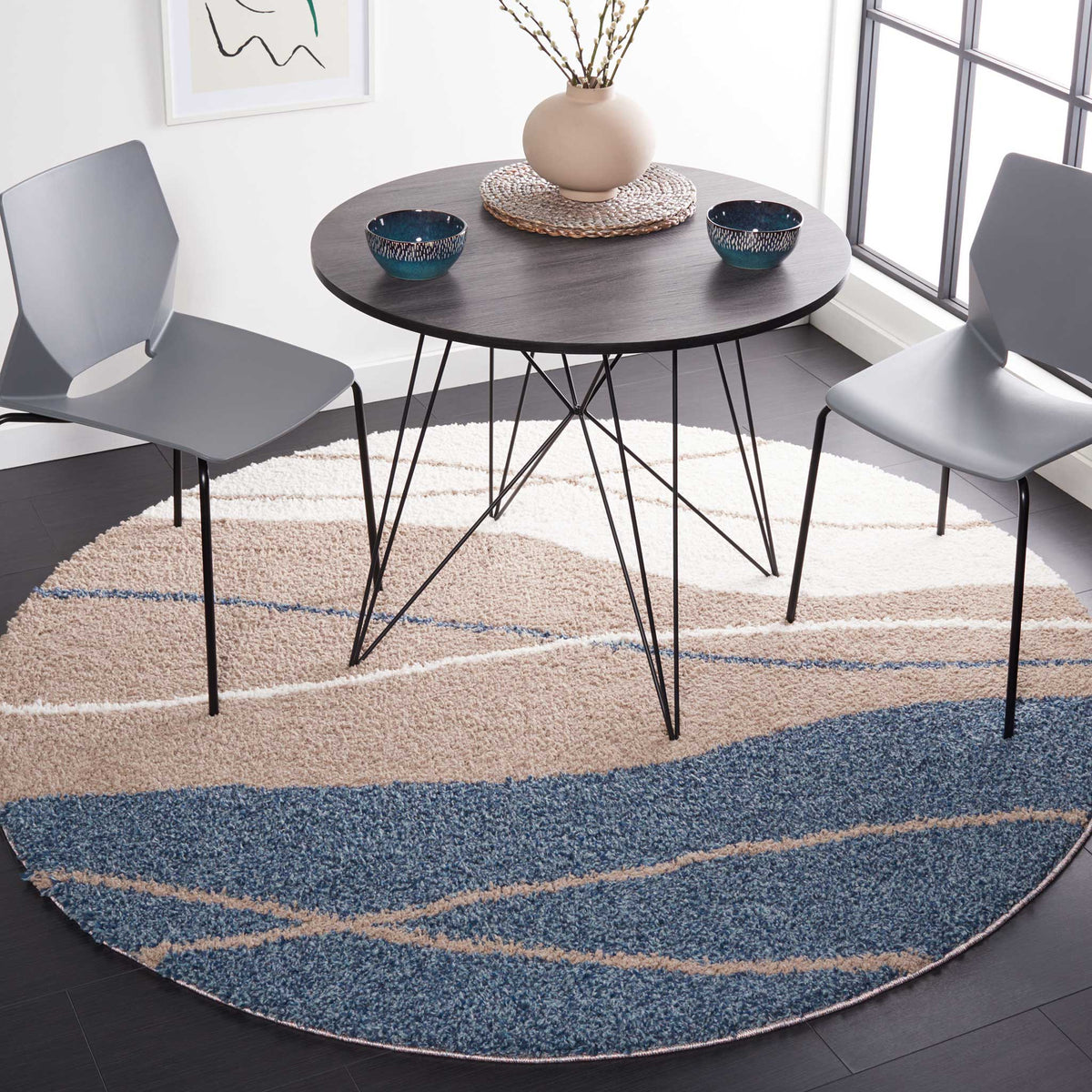 Sweeping blue and taupe hues lend a calm, contemporary feel to a round shag rug