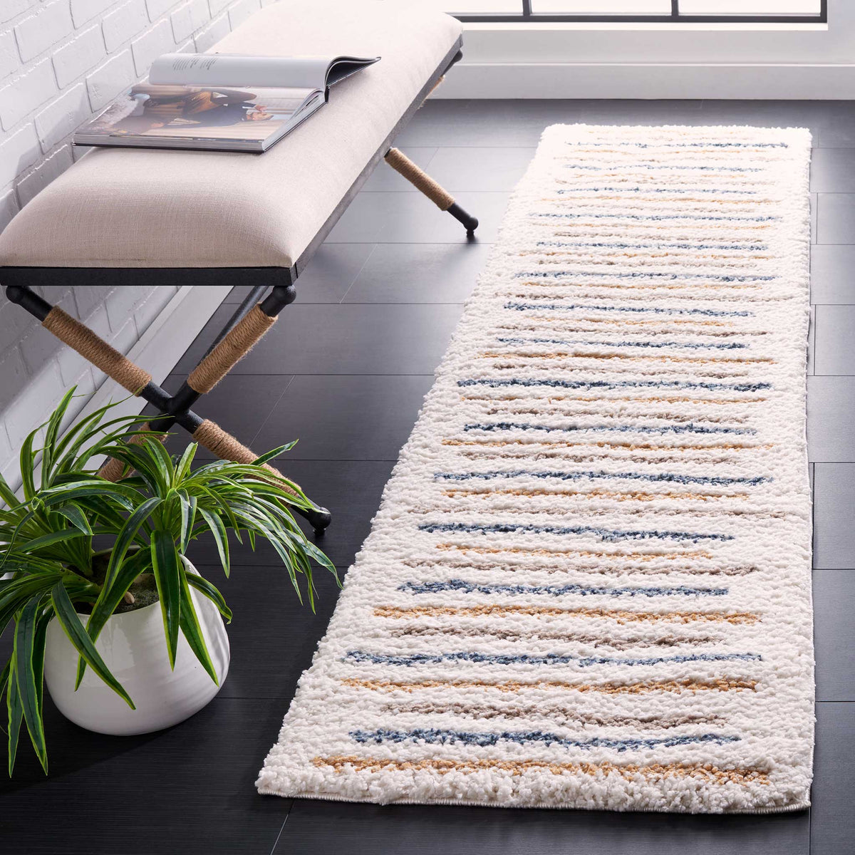 Irregular blue and golden lines add lively color to the plush ivory pile.