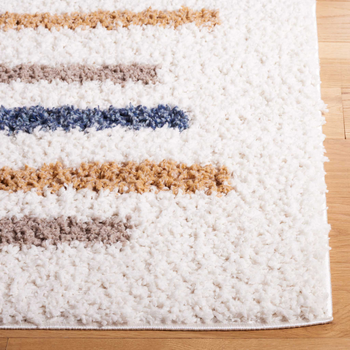 Short blue, gold, and taupe lines contrast with a plush ivory shag edge