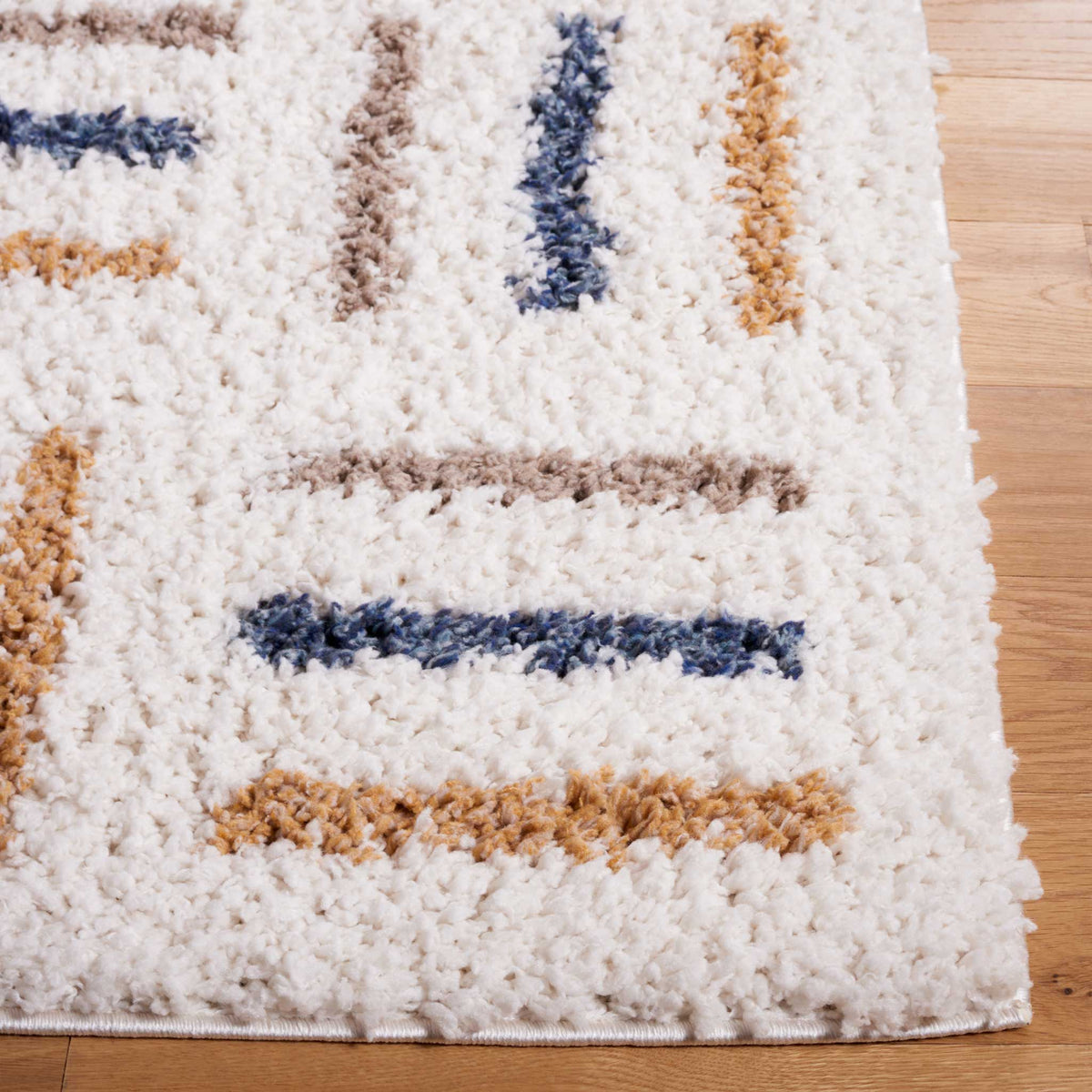 Gold and blue brushstroke lines brighten a fluffy ivory rug edge
