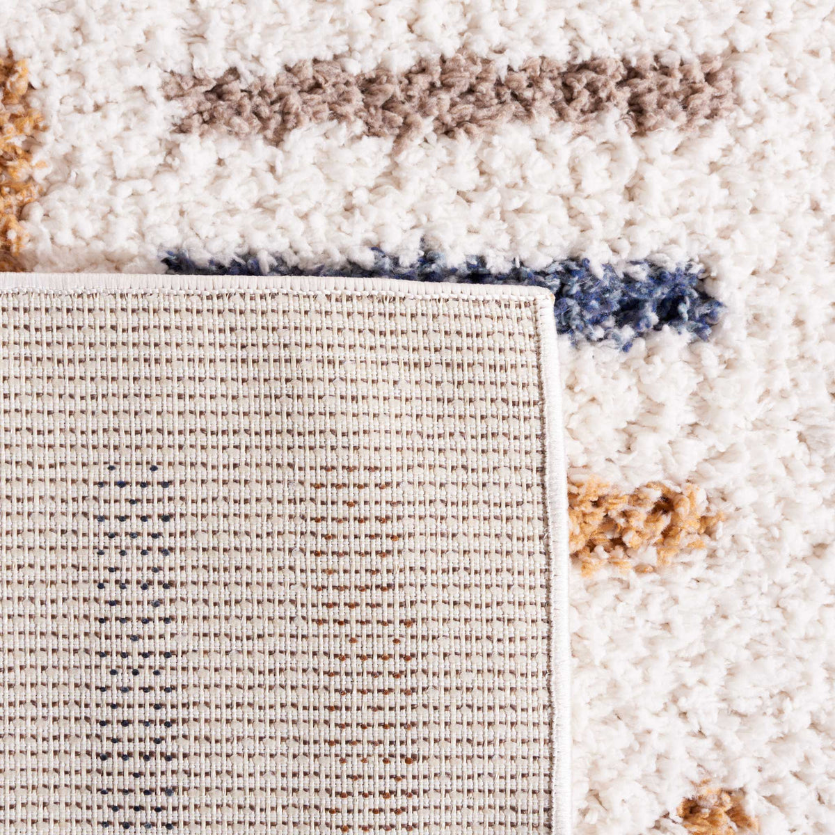 Woven underside and tidy binding balance the rug's shaggy surface