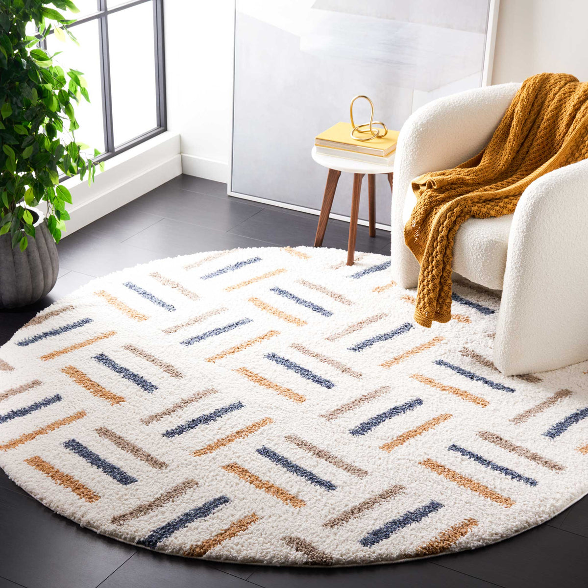 Repeating blue and golden dashes add lively geometry to a round ivory rug