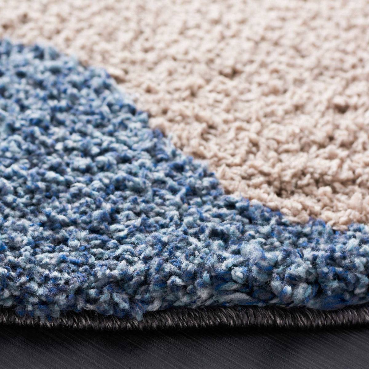 Dense blue and taupe shag meets a bound edge for soft, layered texture