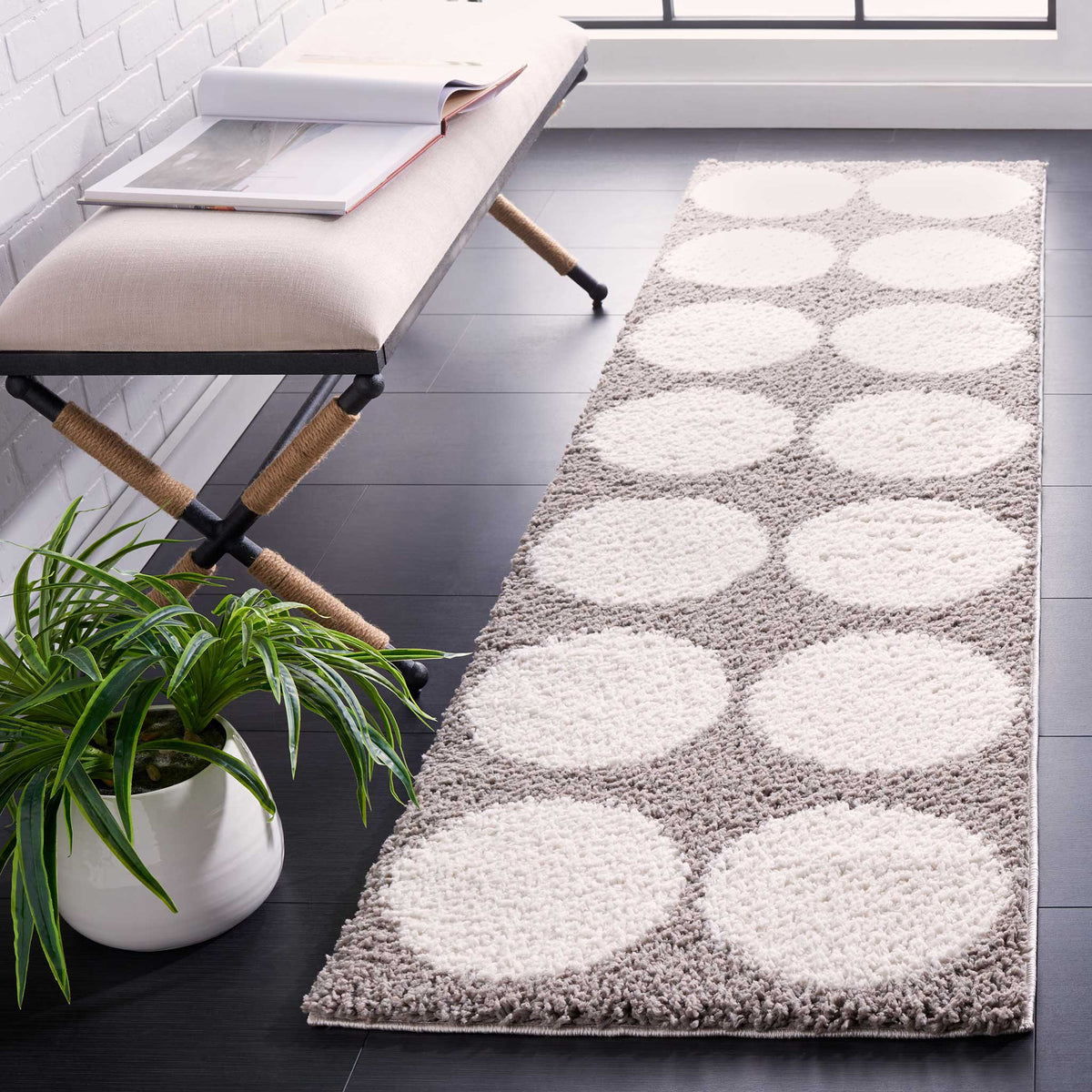 Plush ivory polka dots stand out against the soft gray pile along this narrow runner.