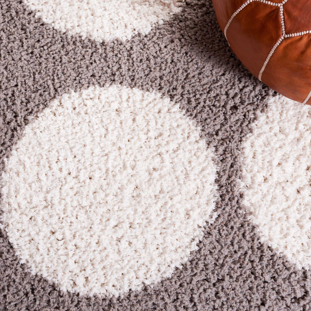 Broad ivory circles and gray shag deliver playful softness underfoot