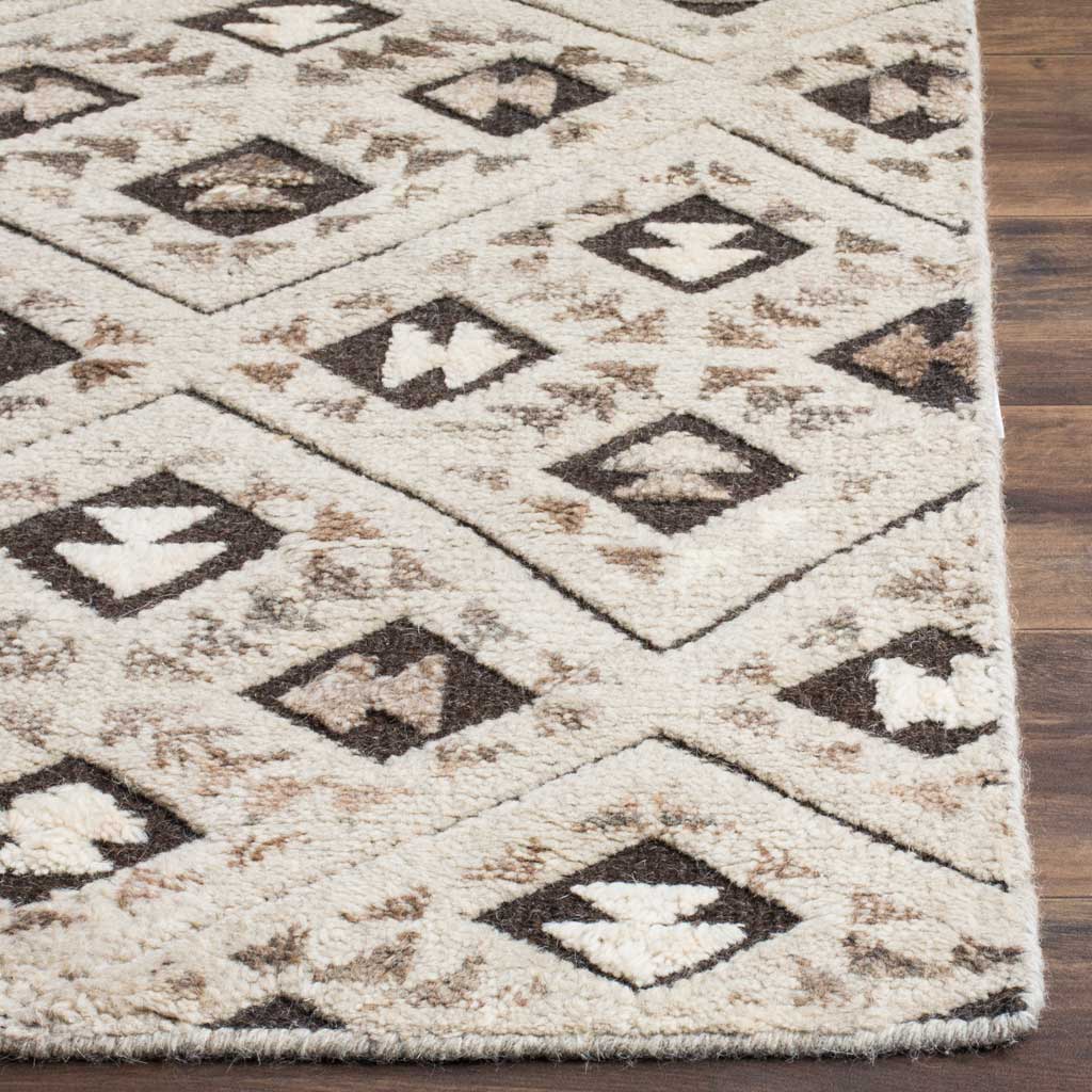 Plush wool texture and dark diamond motifs meet at a neatly finished rug corner