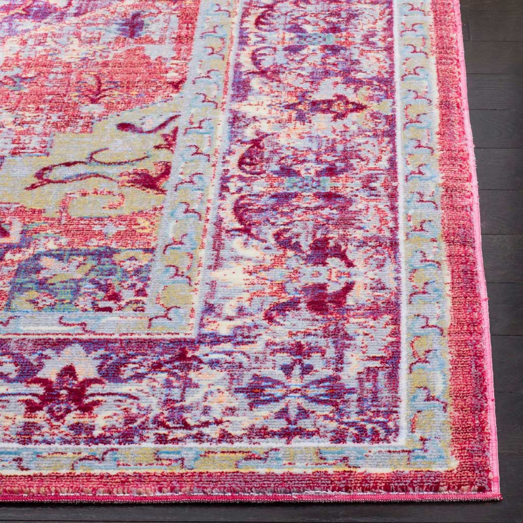 Coral and purple florals flow into a vivid border with a neatly finished rug edge