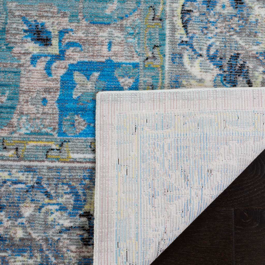 Woven cotton backing supports a blue and light gray rug with delicate floral motifs