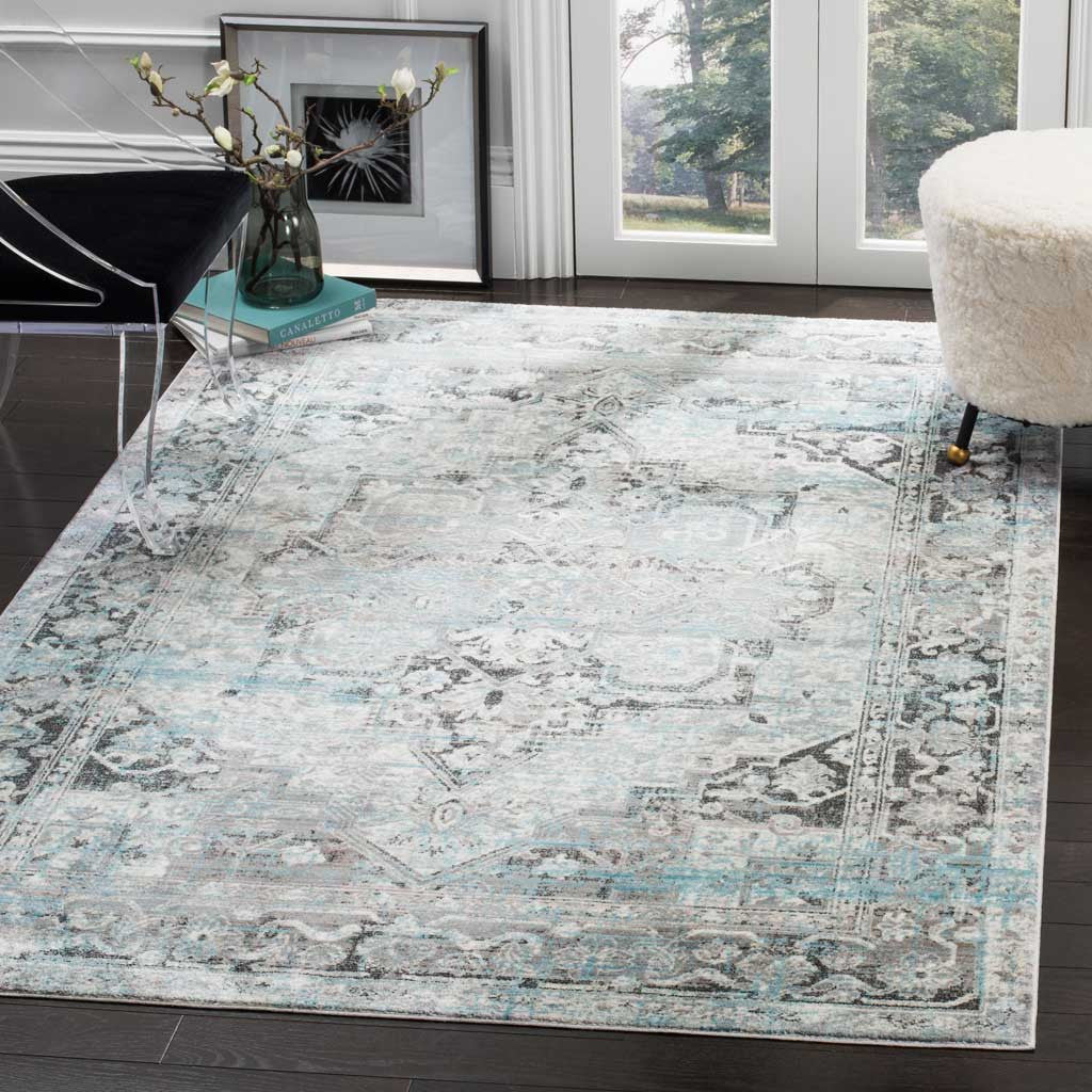 An ivory and gray medallion rug with soft blue accents complements contemporary furnishings.