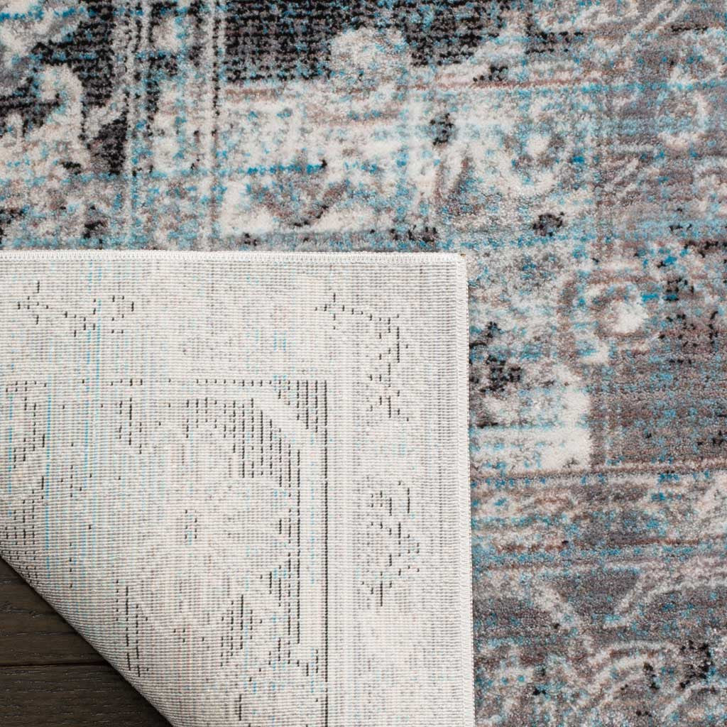 Woven cotton backing supports the rug's blue-accented polyester pile.