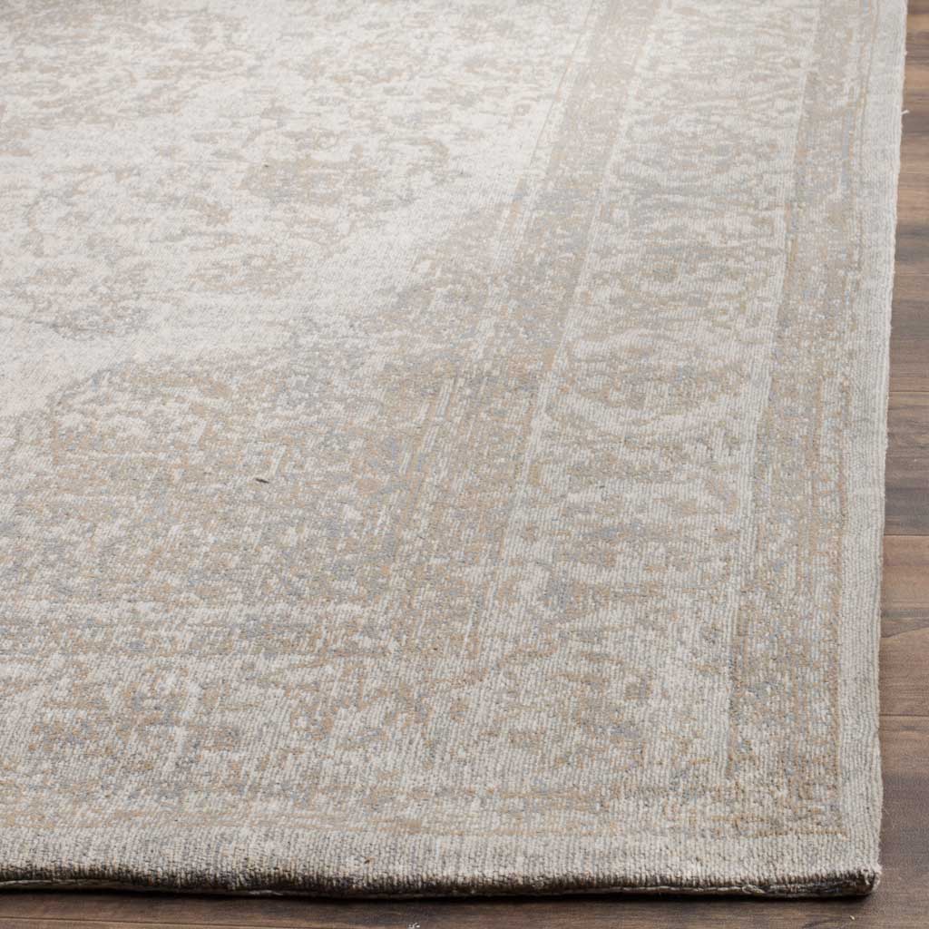 Subtle beige and taupe floral details meet a neatly bound edge with low-profile texture.