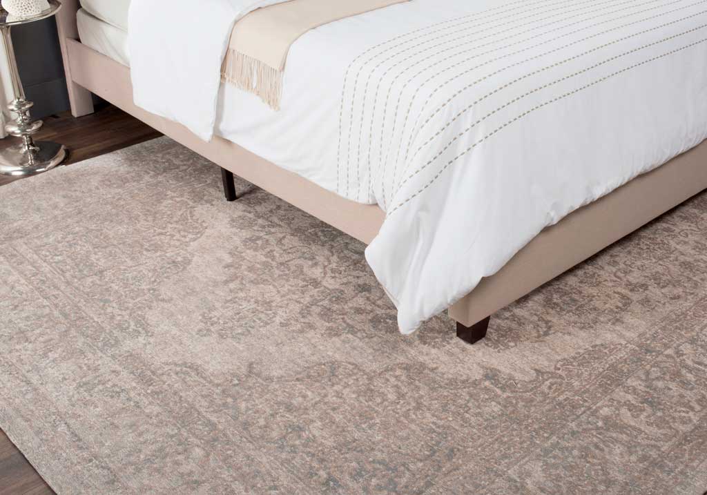 A softly distressed beige floral pattern brings warmth and quiet texture beside the bed.