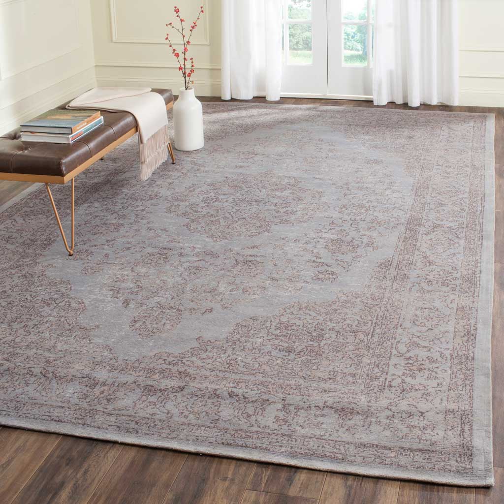 A washed gray floral rug brings gentle pattern to a bright, airy room.