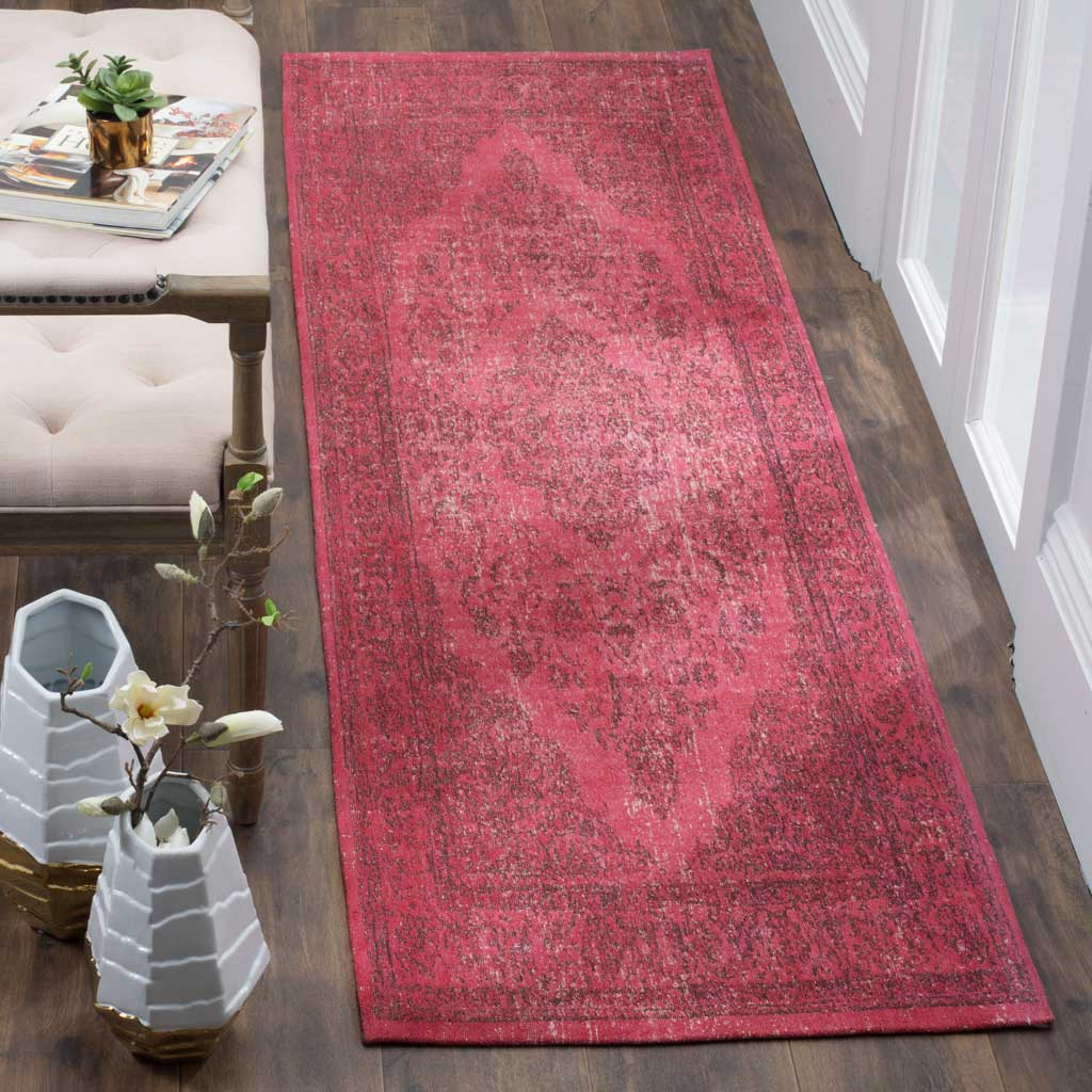Vivid fuchsia runner rug brings a vintage-worn medallion pattern to narrow spaces.