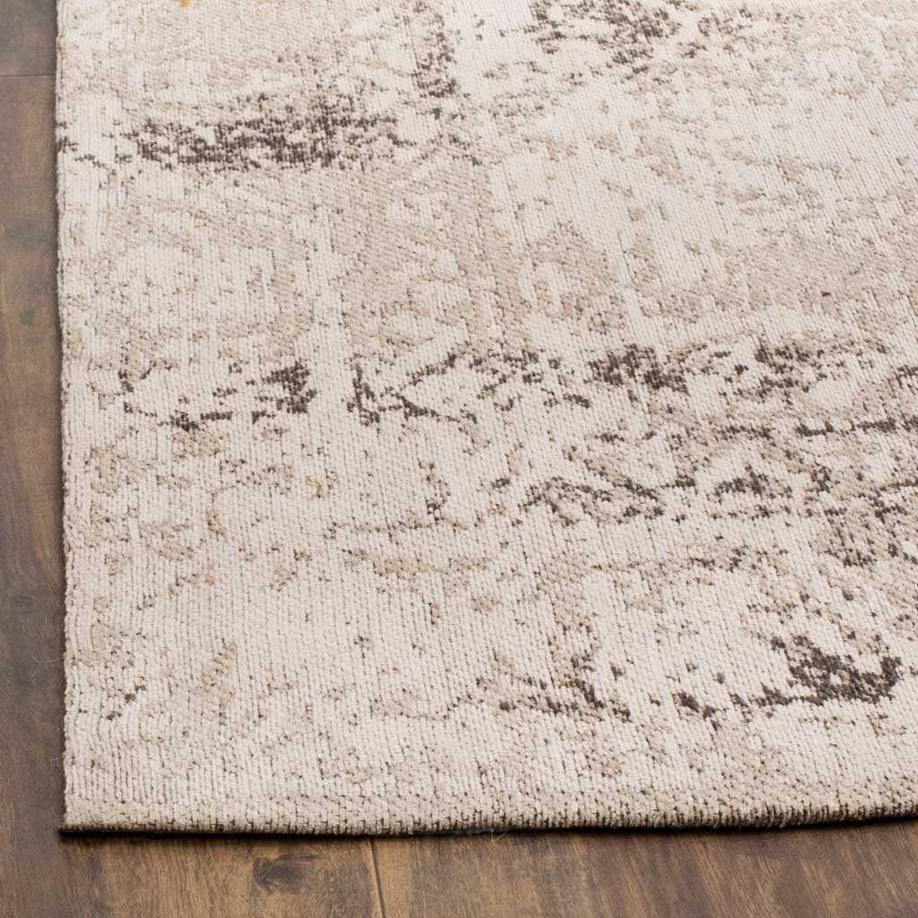 Soft texture meets a neatly finished edge in a weathered cream and charcoal pattern.