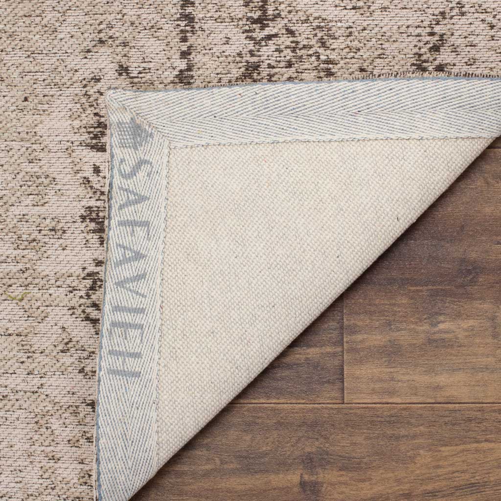 A pale woven underside and reinforced binding finish this softly patterned area rug.