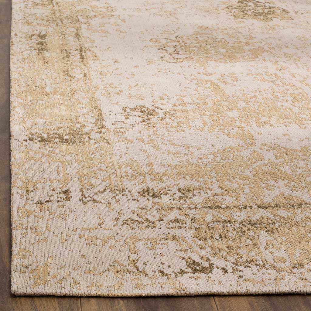 Woven sand and cream fibers show distressed floral texture along a neatly finished edge.