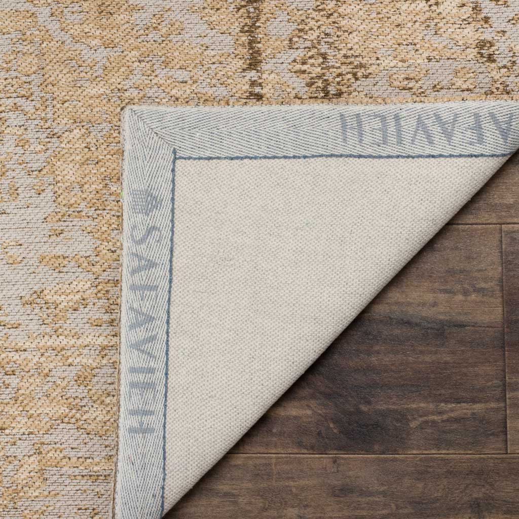 An ivory woven backing and bound corner support the rug's soft sand-colored face.