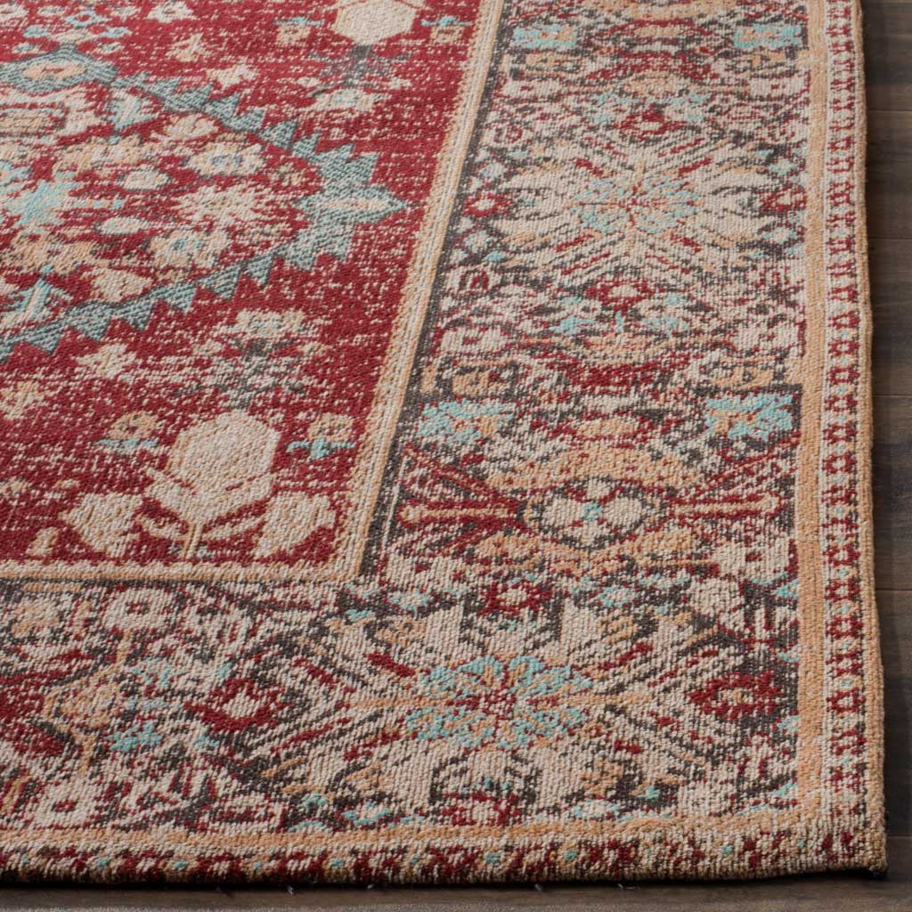 Red, cream, and turquoise florals meet a richly patterned, neatly finished border.