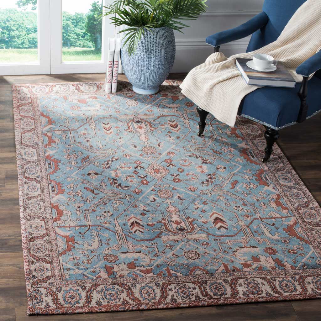 Dusty blue and warm red florals give this ornate area rug welcoming character.