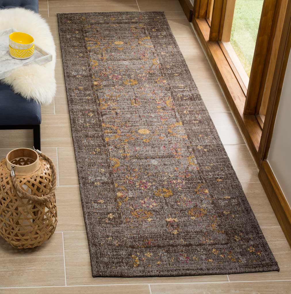 Weathered gray runner rug is flecked with muted gold accents and delicate ornamental details.