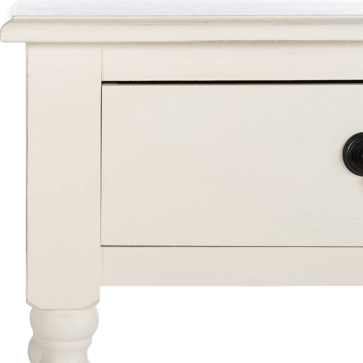 Distressed white finish highlights the framed drawer and gently overhanging tabletop.