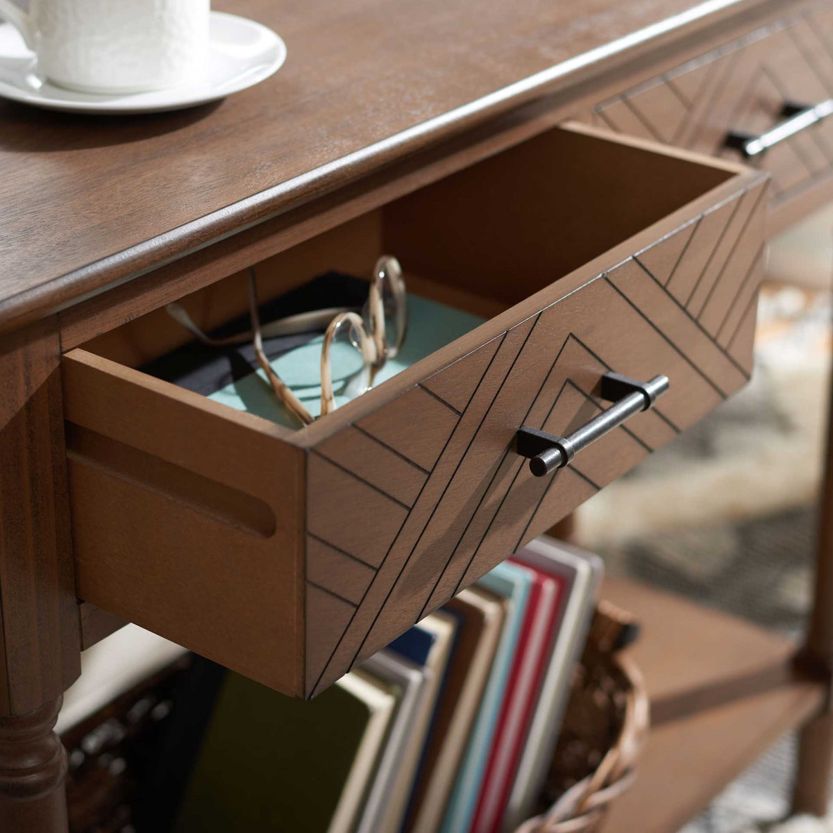 An open patterned drawer offers storage for small essentials above a shelf lined with books