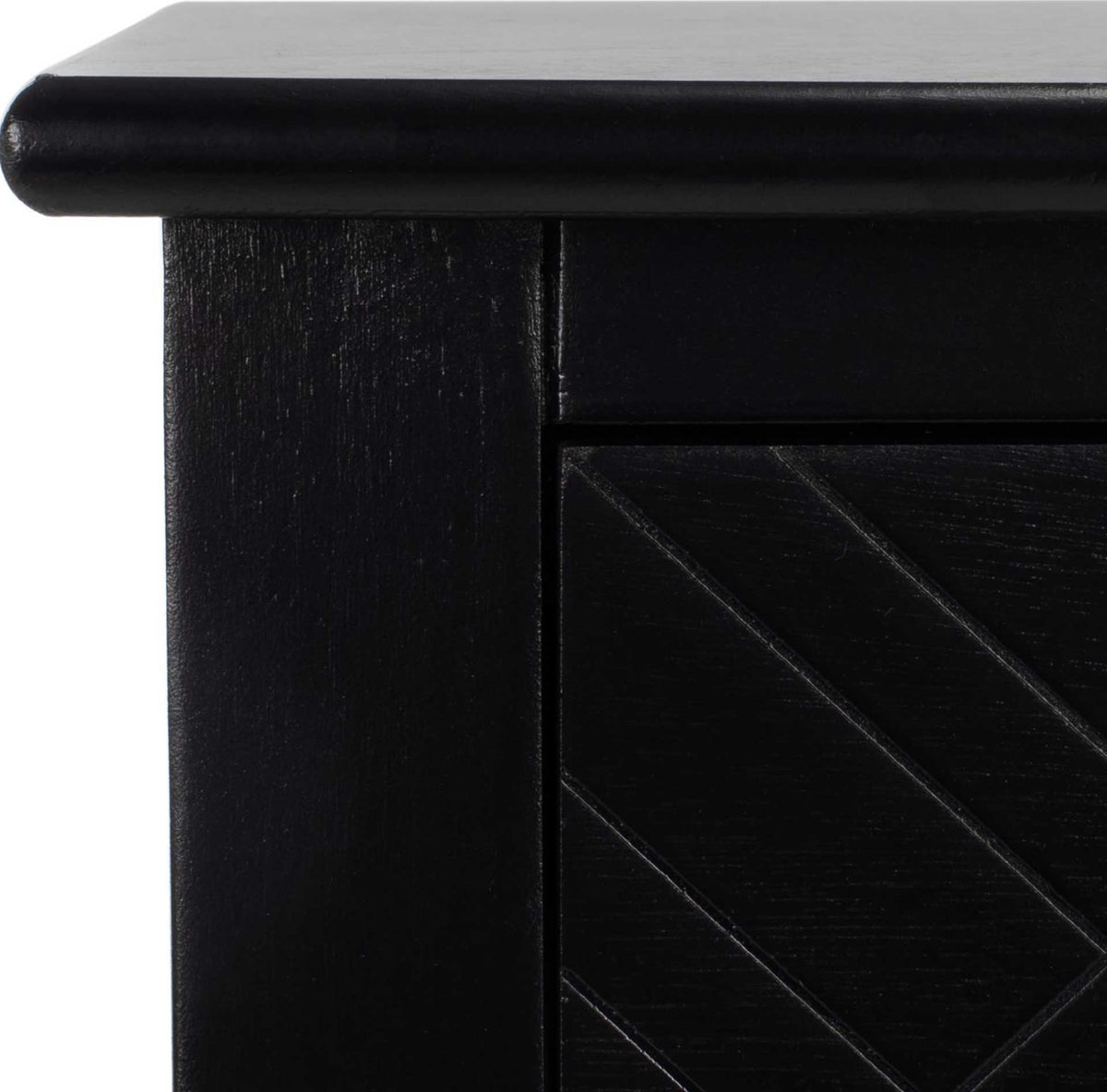 A gently rounded black tabletop edge and angled drawer grooves add refined texture
