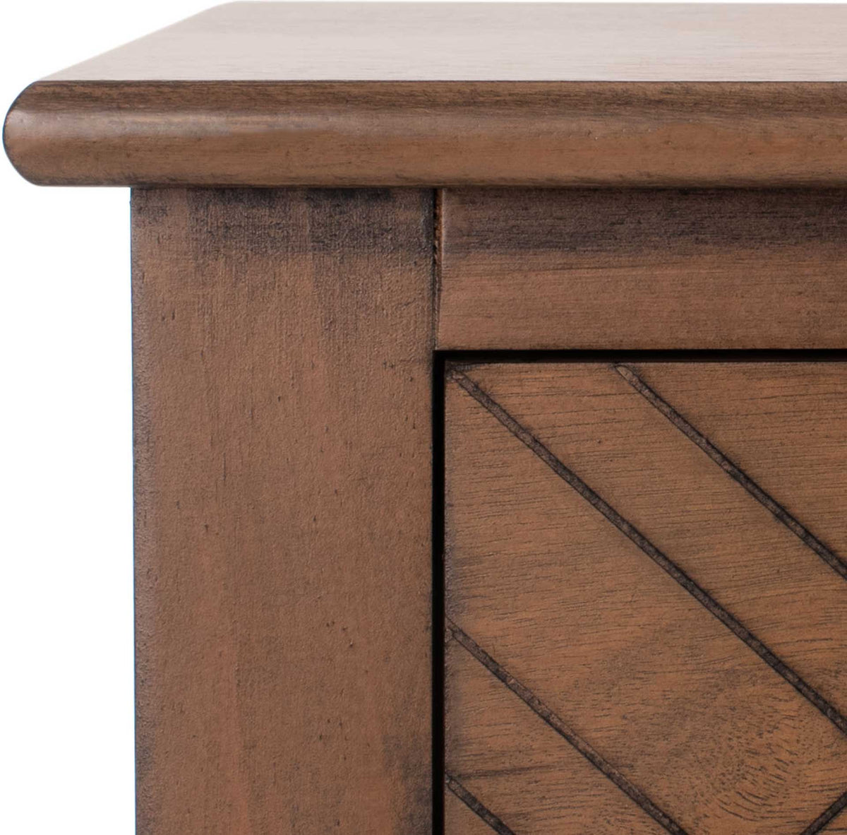 A gently curved brown tabletop edge meets textured wood and grooved geometric drawer detailing