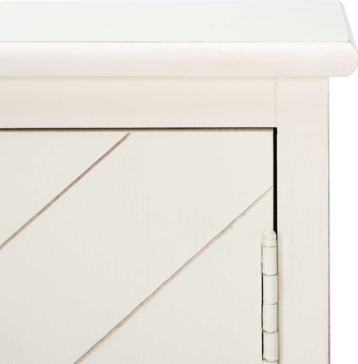 Distressed white paint highlights the wood grain and diagonal door grooves beneath a gently rounded top.
