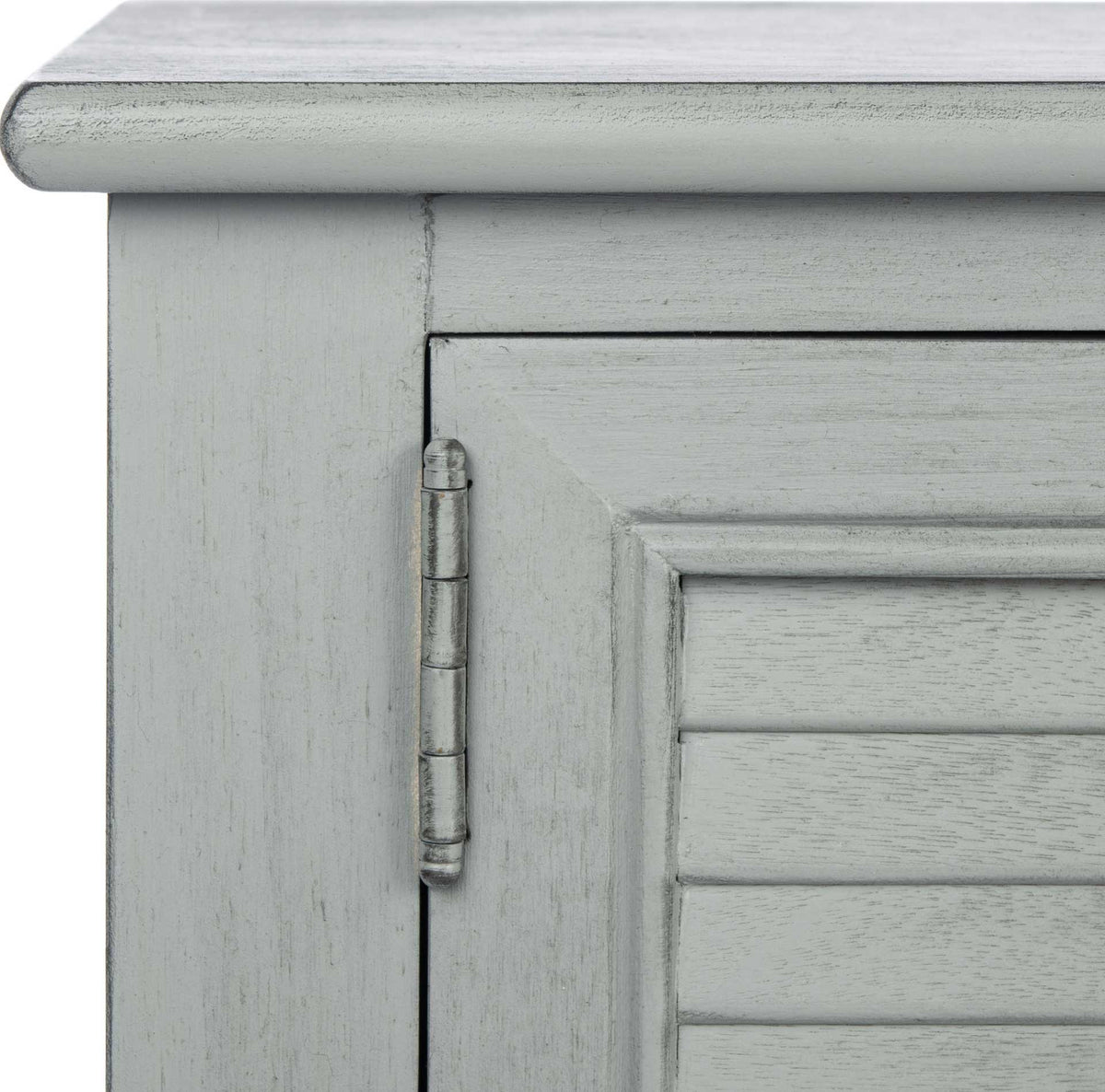 Distressed gray paint softens the rounded top, paneled door frame, and decorative hinge.
