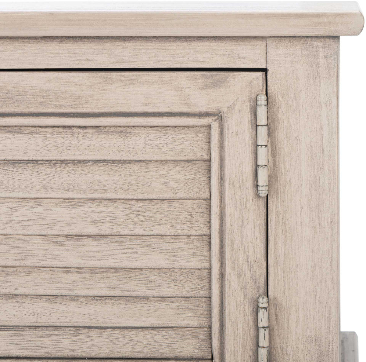 Weathered greige paint emphasizes the wood grain, slatted door, and decorative hinge.