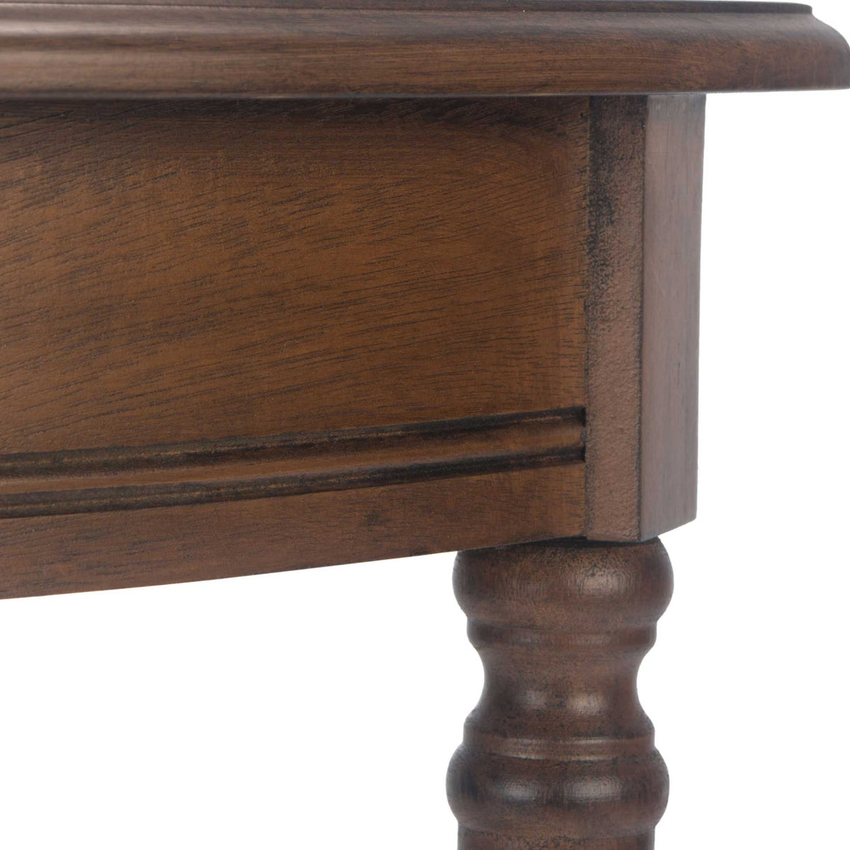 Fine molding and rich brown wood grain distinguish the curved apron and leg joint.