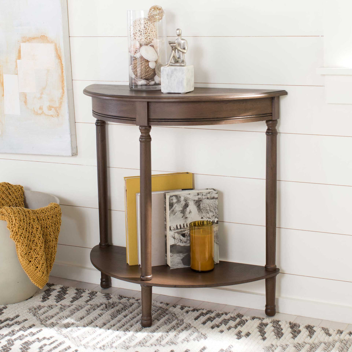 A warm brown console makes room for small decor up top and books on its lower shelf.