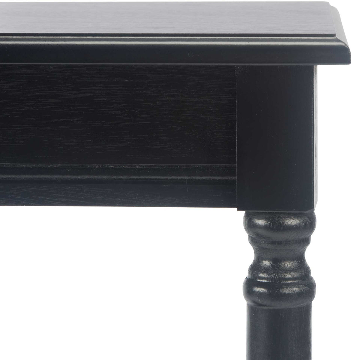 Fine molding beneath the black tabletop meets a decorative turned leg.