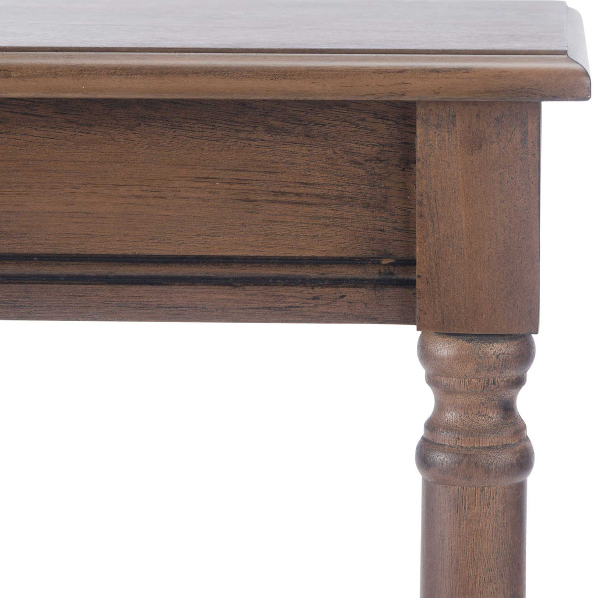 A smooth tabletop edge and molded apron meet above the brown turned leg.