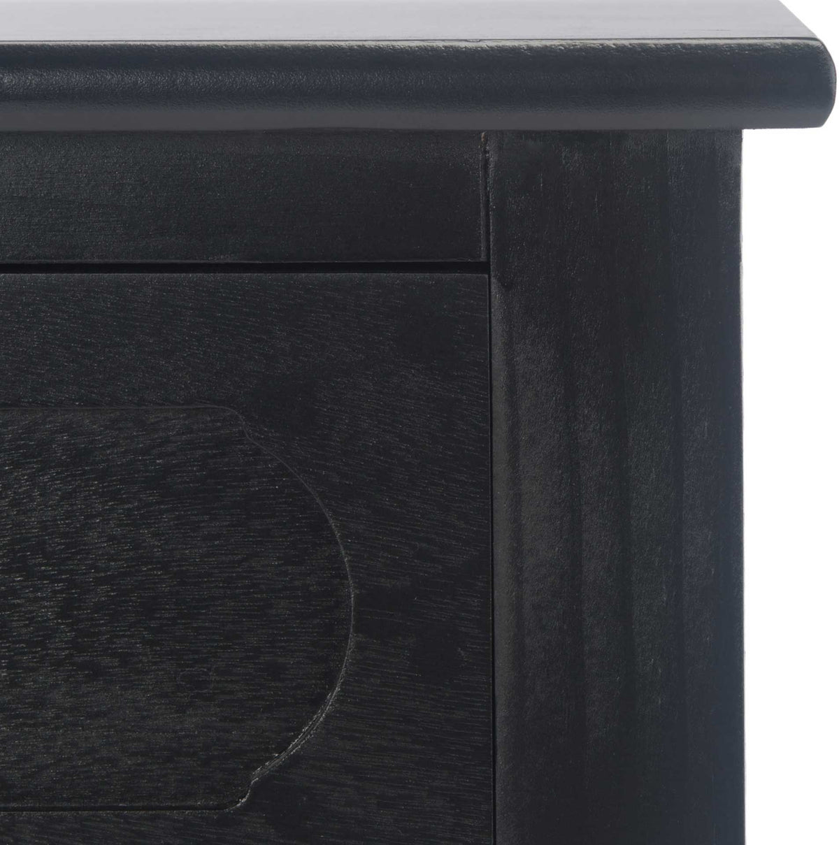 A molded tabletop edge frames the subtle curved detailing of this black console drawer.