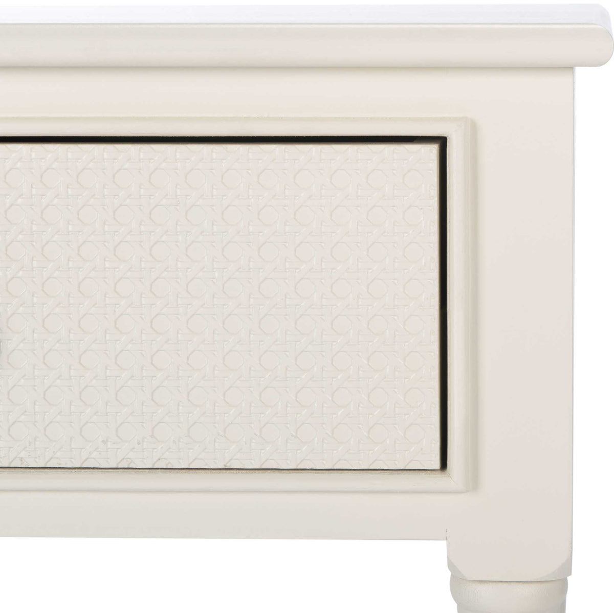 Raised framing surrounds the finely textured drawer inset on a white console table