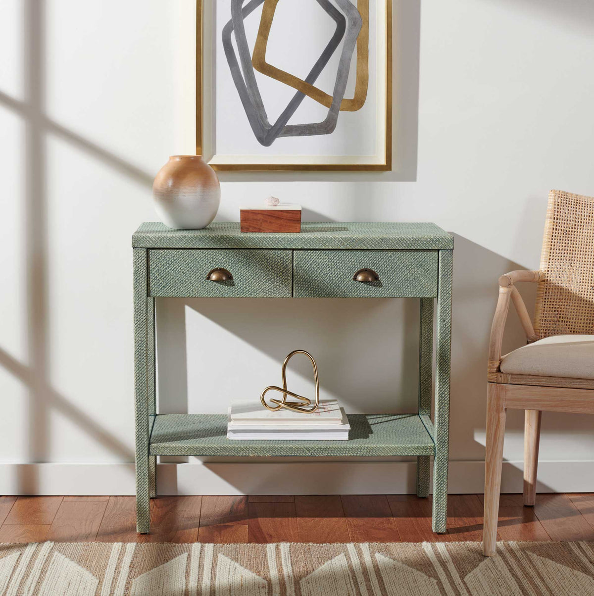 Turquoise console holds a vase on top and books on its lower shelf, with two drawers for small essentials.