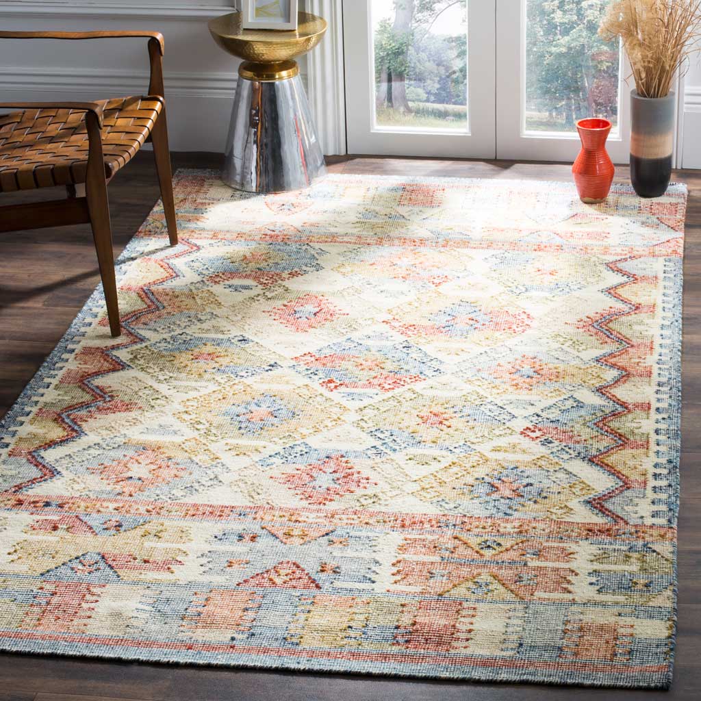 An ivory area rug layers colorful geometric patterns and a warm artisan feel into a living space